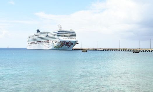 A serene view of a cruise ship docked in St. Croix harbor under clear skies.