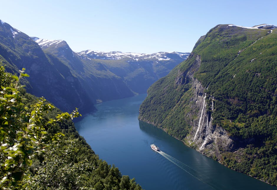 Breathtaking view of Geiranger Fjord with a cruise ship and lush mountains, perfect for nature enthusiasts.